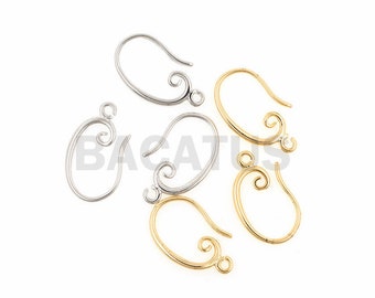 May include: Five earring hooks, two gold and three silver, with a decorative swirl design. The hooks are designed for hanging earrings.