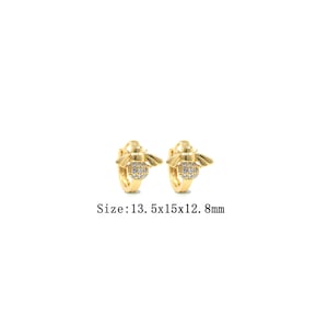 May include: Gold hoop earrings with a bee design featuring clear cubic zirconia stones. Size: 13.5x15x12.8mm.