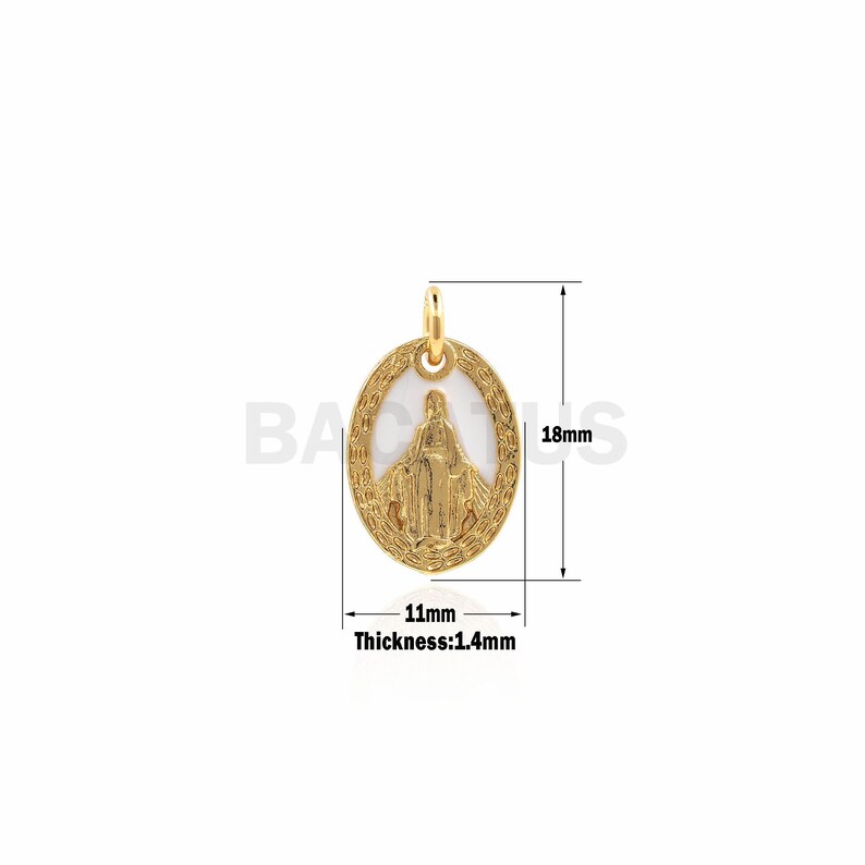 May include: Gold-toned oval pendant featuring a white enamel image of the Virgin Mary. The pendant measures 1.1 inches in length and 0.7 inches in width. The pendant is 0.14 inches thick.