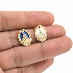 May include: Two gold-colored oval charms with a raised image of the Virgin Mary. One charm has a blue enamel background and the other has a white enamel background.