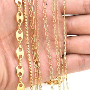 May include: A collection of ten gold chains of different styles and lengths. The chains are arranged in a row on a hand, with the longest chain at the top and the shortest chain at the bottom.