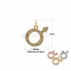 May include: Gold-tone pendant charm with a circle and arrow design, encrusted with clear rhinestones. The charm measures 16 mm in diameter and 18 mm in height. The pendant is 1.5 mm thick.