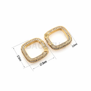 May include: Two gold-toned square-shaped clasps with clear crystal embellishments. Each clasp measures 1.78 inches by 1.78 inches and 0.35 inches in width.