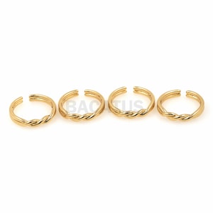 May include: Four gold-toned twisted wire rings. The rings are simple and delicate, perfect for stacking or wearing alone.