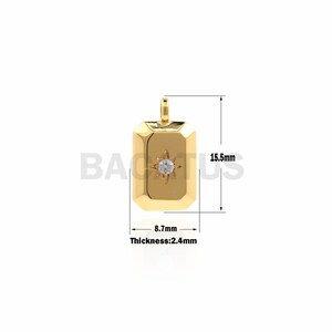 May include: Gold pendant charm with a clear rhinestone star in the centre. The pendant is rectangular with rounded corners and measures 8.7 mm wide by 15.5 mm tall. The pendant is 2.4 mm thick.