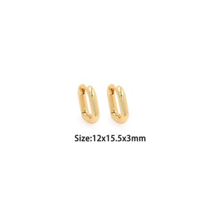 May include: A pair of gold-toned hoop earrings with a rectangular shape. The earrings are approximately 12mm x 15.5mm x 3mm in size.  Size: 12x15.5x3mm