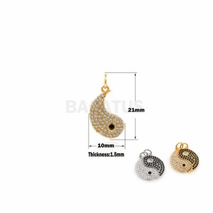 May include: Gold-tone yin yang pendant charm with clear cubic zirconia stones. The pendant is 21 mm tall and 10 mm wide. The pendant is 1.5 mm thick.