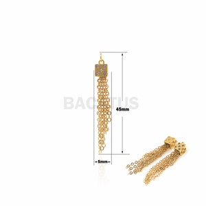 May include: Gold-colored earrings with a square top adorned with four small, clear stones. The earrings feature multiple dangling chains, with a total length of 45mm and a width of 5mm. The earrings are displayed on a white background.
