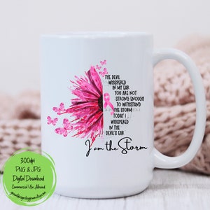 May include: White ceramic coffee mug with a pink and white sunflower design and the text "The devil whispered in my ear you are not strong enough to withstand the storm today I whispered in the devil's ear I am the storm".