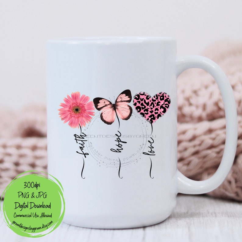 May include: White ceramic mug with a pink butterfly, flower, and heart with a leopard print design. The words "faith", "hope", and "love" are written around the design.