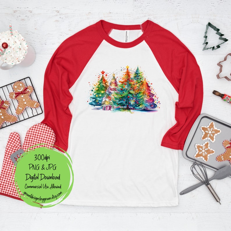 May include: A white and red baseball tee shirt with a colorful watercolor design of Christmas trees with lights and ornaments. The text "300dpi PNG & JPG Digital Download Commercial Use Allowed" is on the bottom of the shirt.