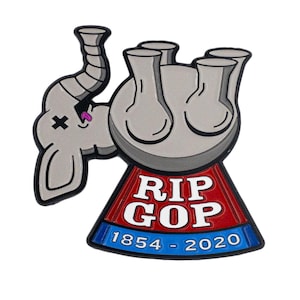 May include: A metal enamel pin featuring a gray elephant with a black X over one eye and a pink tongue sticking out. The elephant is positioned next to a red and blue tombstone shape with the white text RIP GOP and 1854 - 2020 printed on it.