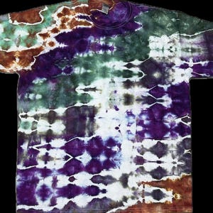 May include: A tie-dye t-shirt with a colourful pattern of purple, green, brown, and white. The shirt has a crew neck and short sleeves.
