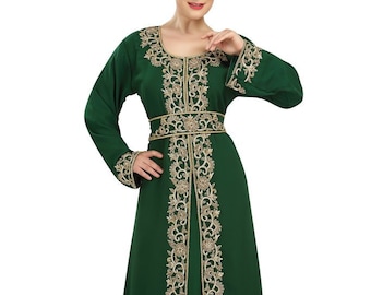 May include: A long, green dress with gold embroidery. The dress has a round neckline and long sleeves. The embroidery is on the neckline, sleeves, and hem of the dress.