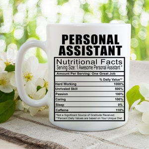 May include: White ceramic coffee mug with a black design that reads "Personal Assistant" and a nutritional facts label listing "Hard Working", "Unrivaled Skill", "Passion", "Caring", "Sleep", and "Caffeine" with percentages next to each item.