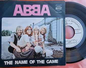 ABBA The Name Of The Game 1977 Single Jugoslavia 7" 45 RPM Oryginalna koszulka Agnetha Fältskog Björn Ulvaeus ABBA Pamiątki