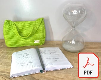 May include: A green crocheted handbag with a white label that says "Lunda" on it. A notebook with a floral design and handwritten to-do list is open on a wooden table. A glass hourglass with white sand is on the table. A red PDF icon is in the lower right corner of the image.