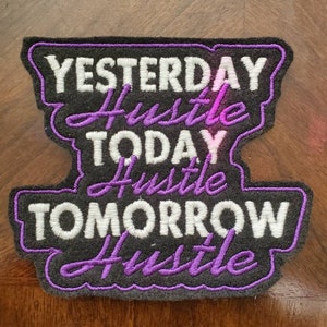 May include: A black embroidered patch with white text that reads "Yesterday Hustle Today Hustle Tomorrow Hustle" and purple stitching around the edges.