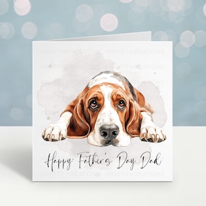 May include: A Father's Day card with a watercolour illustration of a Basset Hound. The dog is depicted in brown, white, and black, with a melancholic expression. The words "Happy Father's Day Dad" are written in cursive below the dog.