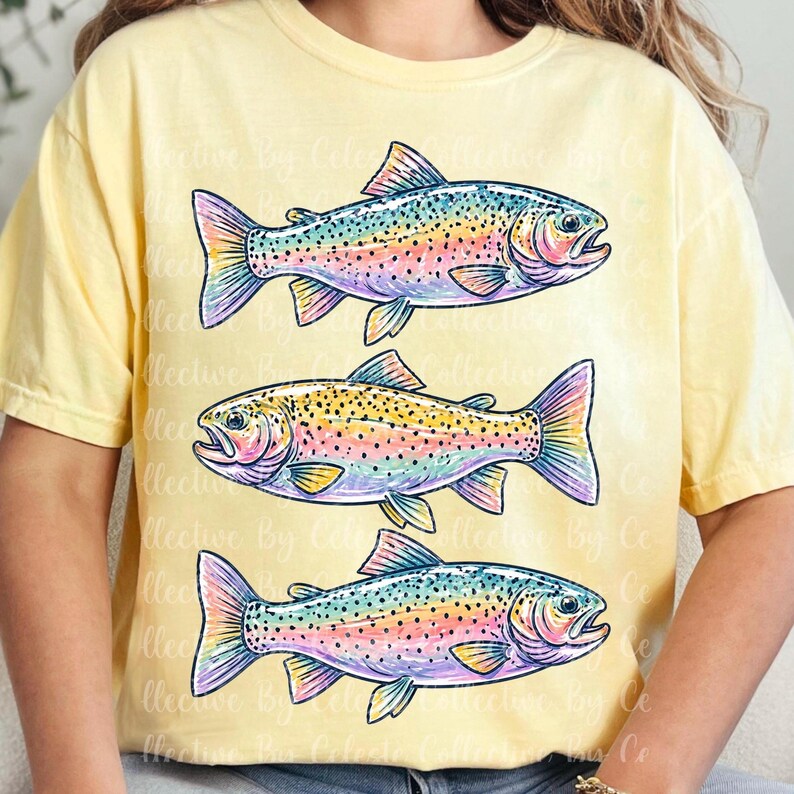 May include: Yellow t-shirt featuring three colorful rainbow trout illustrations. The fish are depicted with a variety of colors, including pink, blue, yellow, and orange. The shirt has a relaxed fit.