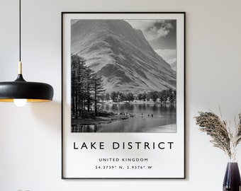 May include: Black and white photograph of a mountain range and lake with the text "LAKE DISTRICT" and "UNITED KINGDOM" below the image. The coordinates "54.3719° N, 2.9376° W" are listed below the text.