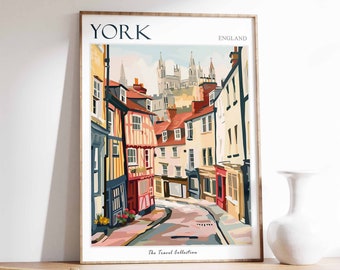 May include: A colorful illustration of a street scene in York, England. The image features a narrow street lined with colorful buildings, with a church in the background. The text "YORK" and "ENGLAND" are visible at the top of the image. The text "The Travel Collection" is visible at the bottom of the image.