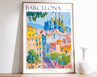 May include: A colorful illustration of the Sagrada Familia in Barcelona, Spain. The image is framed and features a blue, yellow, and pink color scheme. The text "BARCELONA SPAIN" is at the top of the image, and "The Travel Collection" is at the bottom.