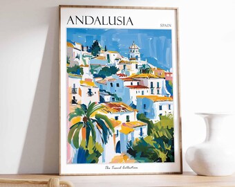 May include: A colorful illustration of a cityscape with white buildings and red rooftops. The illustration is framed in a wooden frame and has the text "ANDALUSIA SPAIN" at the top and "The Travel Collection" at the bottom.
