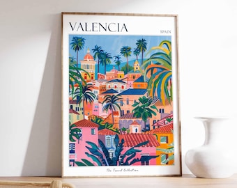 May include: A colorful illustrated poster of Valencia, Spain, with the text "Valencia" and "Spain" at the top. The poster features a cityscape with buildings, palm trees, and a blue sky. The text "The Travel Collection" is at the bottom of the poster.