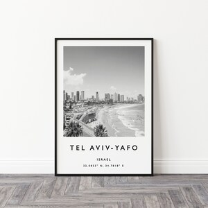 May include: Black and white photograph of Tel Aviv-Yafo, Israel. The image shows a cityscape with buildings along the beach. The text "Tel Aviv-Yafo" and "Israel" is printed below the image, along with the coordinates "32.0853&deg; N, 34.7818&deg; E".