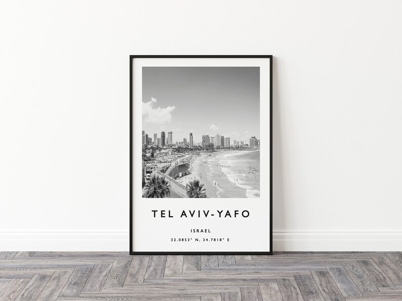 May include: Black and white photograph of Tel Aviv-Yafo, Israel. The image shows a cityscape with buildings along the beach. The text "Tel Aviv-Yafo" and "Israel" is printed below the image, along with the coordinates "32.0853&deg; N, 34.7818&deg; E".