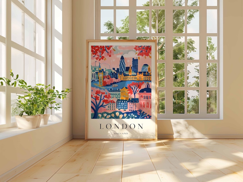 Peut inclure: Une illustration color&eacute;e de Londres, en Angleterre, avec un ciel rose et une ville avec des b&acirc;timents, des arbres et une rivi&egrave;re. Le texte "LONDON ENGLAND" est en bas de l'image.