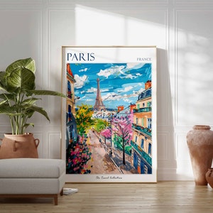 May include: A colorful painting of a Parisian street scene with the Eiffel Tower in the background. The painting is framed in a gold frame and has the text "PARIS FRANCE" at the top. The text "The Travel Collection" is at the bottom of the painting.