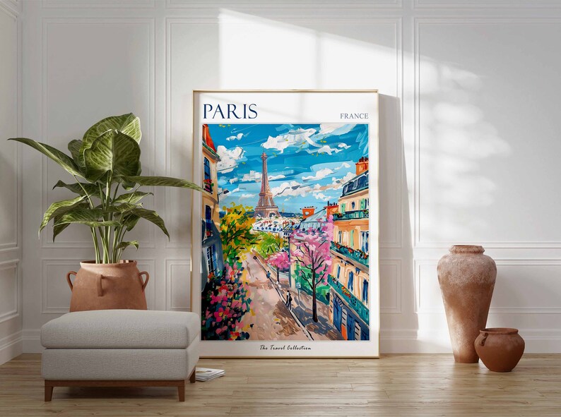 May include: A colorful painting of a Parisian street scene with the Eiffel Tower in the background. The painting is framed in a gold frame and has the text "PARIS FRANCE" at the top. The text "The Travel Collection" is at the bottom of the painting.