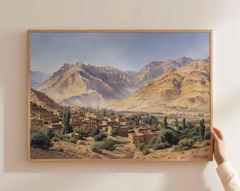May include: A painting depicting a village nestled in a valley surrounded by brown mountains. The sky is a light blue with white clouds. The village is made up of small, brown buildings with flat roofs. There are trees scattered throughout the valley.