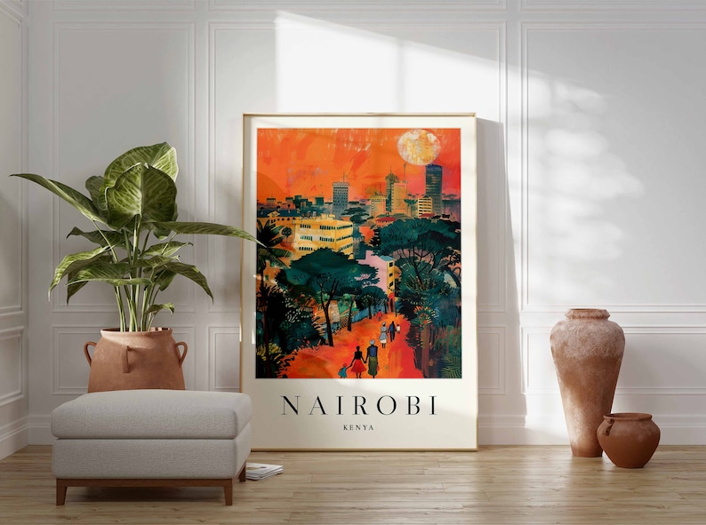 May include: A framed art print of Nairobi, Kenya, featuring a vibrant cityscape under an orange sky with a large moon. The artwork depicts buildings, trees, and figures walking on a path, with the city name and country at the bottom.