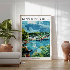May include: A framed art print of Kennebunkport, Maine, featuring a watercolor-style depiction of a coastal town with boats, buildings, and lush greenery. The print is in a gold frame and is part of "The Travel Collection."