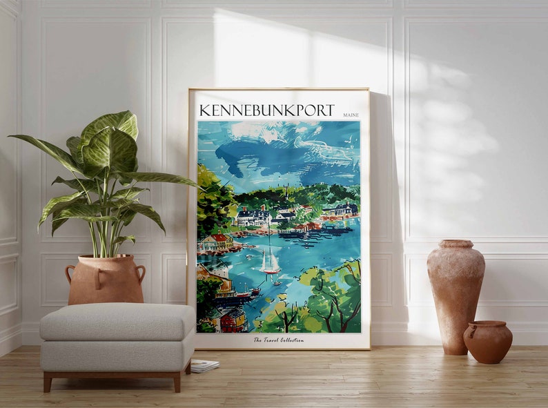 May include: A framed art print of Kennebunkport, Maine, featuring a watercolor-style depiction of a coastal town with boats, buildings, and lush greenery. The print is in a gold frame and is part of "The Travel Collection."