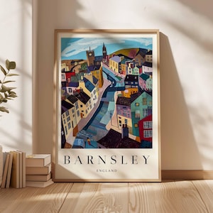 Puede incluir: Una impresi&oacute;n art&iacute;stica enmarcada que presenta una representaci&oacute;n colorida y estilizada de Barnsley, Inglaterra. La obra de arte muestra un paisaje urbano con edificios de varios colores, una carretera central y una torre de iglesia. Las palabras "BARNSLEY" y "ENGLAND" est&aacute;n impresas en la parte inferior.