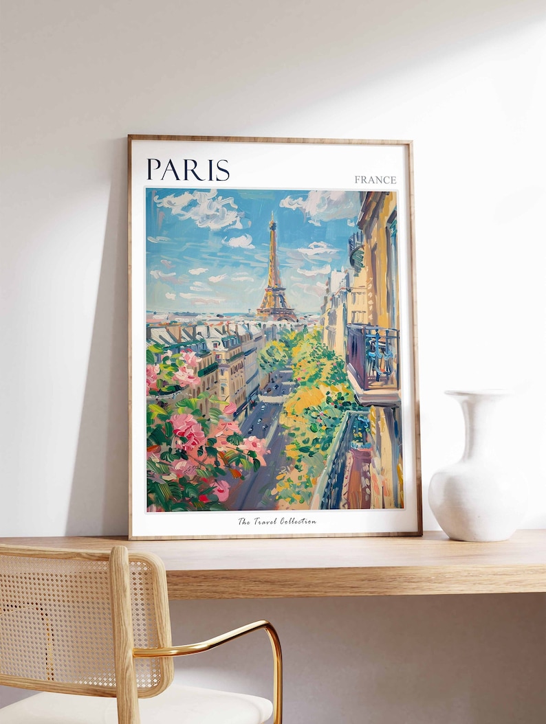 Pode incluir: Uma impress&atilde;o emoldurada de uma pintura que retrata uma vista de Paris, Fran&ccedil;a. A Torre Eiffel &eacute; vis&iacute;vel ao fundo, com edif&iacute;cios e &aacute;rvores em primeiro plano. A impress&atilde;o tem o texto "PARIS" e "FRANCE" no topo, e "The Travel Collection" na parte inferior.