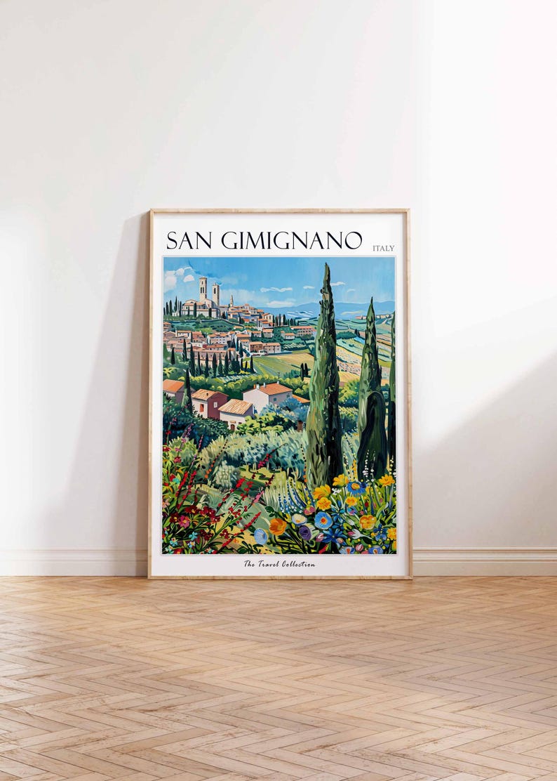 May include: A vintage travel poster featuring a colorful illustration of San Gimignano, Italy. The poster has a light blue sky with white clouds, a green hillside with trees and houses, and a view of the town's iconic towers in the distance. The text "SAN GIMIGNANO" and "ITALY" is printed in black at the top of the poster. The text "The Travel Collection" is printed in black at the bottom of the poster.