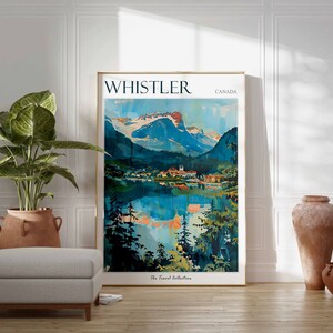 May include: A vintage travel poster with a blue and green mountain landscape reflected in a lake. The poster is framed in gold and has the text "WHISTLER CANADA" at the top. The text "The Travel Collection" is at the bottom.