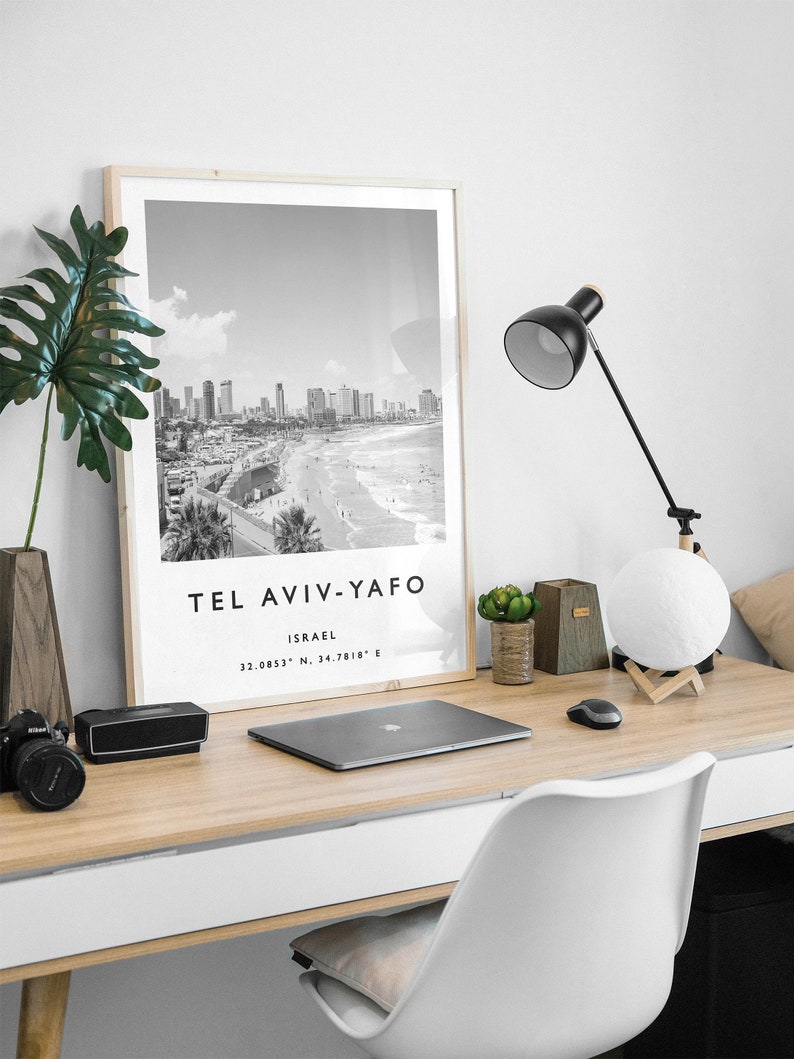 May include: Black and white photograph of Tel Aviv-Yafo, Israel, with the city skyline and beach in the background. The text "Tel Aviv-Yafo" and "Israel" is printed below the image, along with the coordinates "32.0853&deg; N, 34.7818&deg; E".