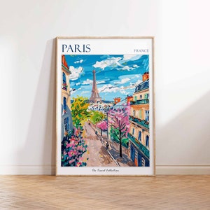 May include: A colorful painting of a Parisian street scene with the Eiffel Tower in the background. The painting features a street lined with buildings, trees, and flowers. The text "PARIS" and "FRANCE" are at the top of the painting, and the text "The Travel Collection" is at the bottom.