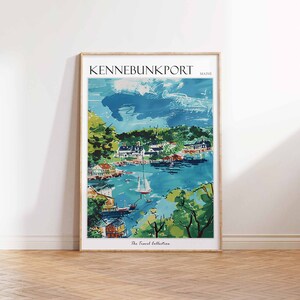 May include: A framed art print of Kennebunkport, Maine, featuring a coastal town scene. The artwork depicts a harbor with boats, buildings, and lush greenery under a blue sky. The text "KENNEBUNKPORT MAINE" is at the top. The Travel Collection is at the bottom.