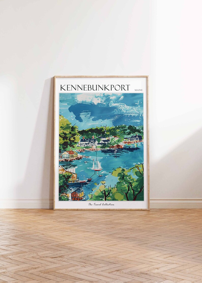 May include: A framed art print of Kennebunkport, Maine, featuring a coastal town scene. The artwork depicts a harbor with boats, buildings, and lush greenery under a blue sky. The text "KENNEBUNKPORT MAINE" is at the top. The Travel Collection is at the bottom.