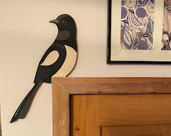 Hand painted single magpie to sit on a door corner.