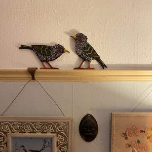 Pair of starlings to sit on a door frame, picture rail or similar.