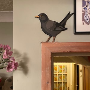 Hand painted blackbird to sit on a door frame, picture rail or shelf