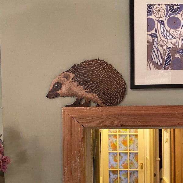 Hand painted hedgehog to sit on a door frame, picture rail or similar